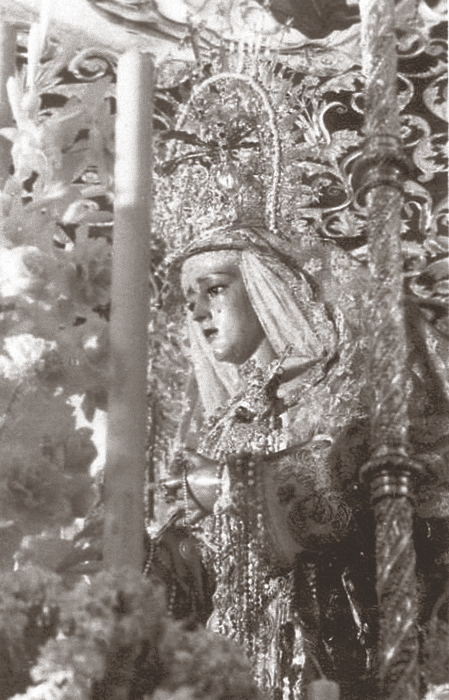 La Virgen de la Caridad del Baratillo se nos muestra muy enjoyada, al estilo de la época, en esta fotografía de los años cincuenta.